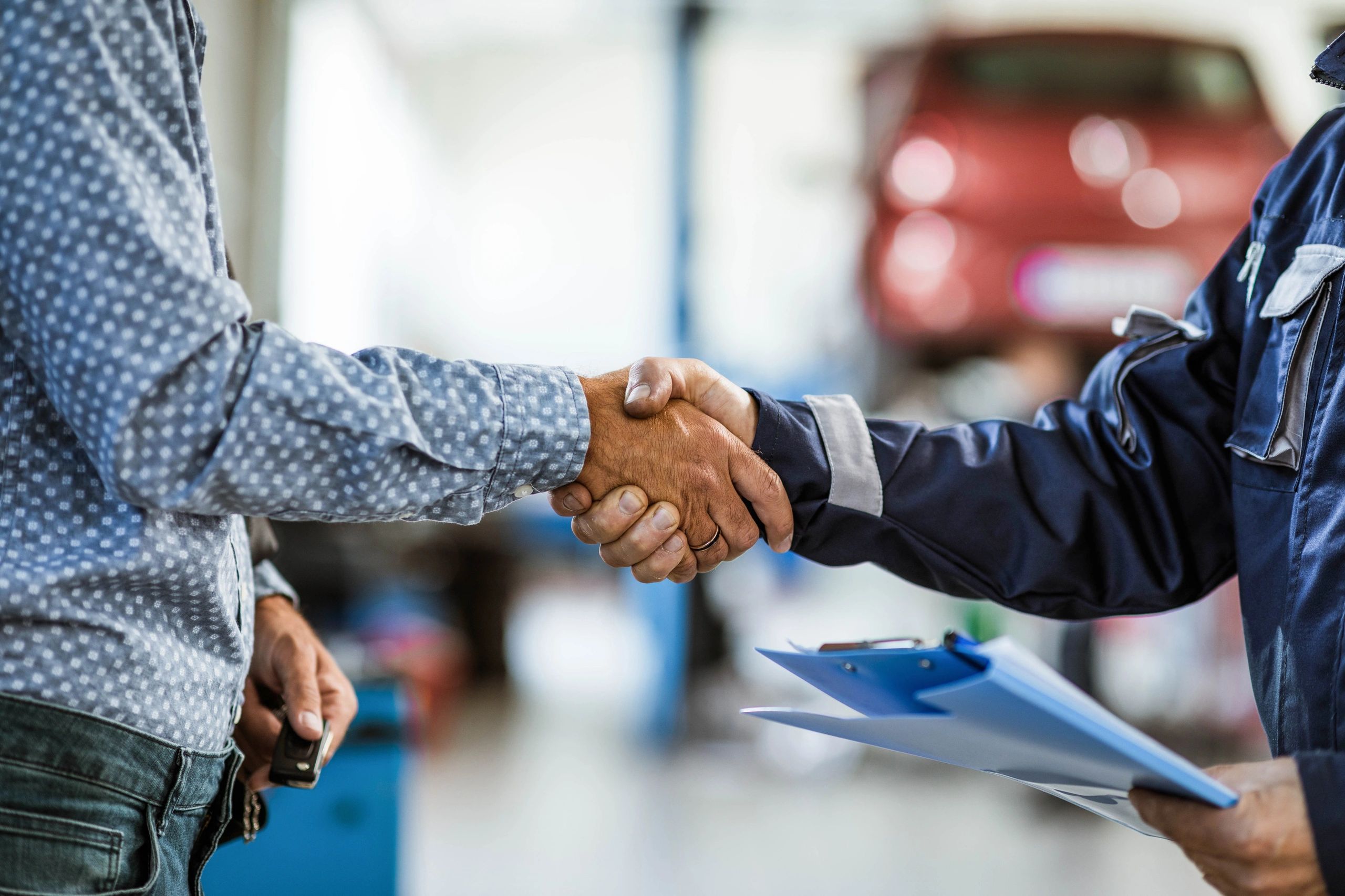 Mechanic shaking hands with a customer after service completion
