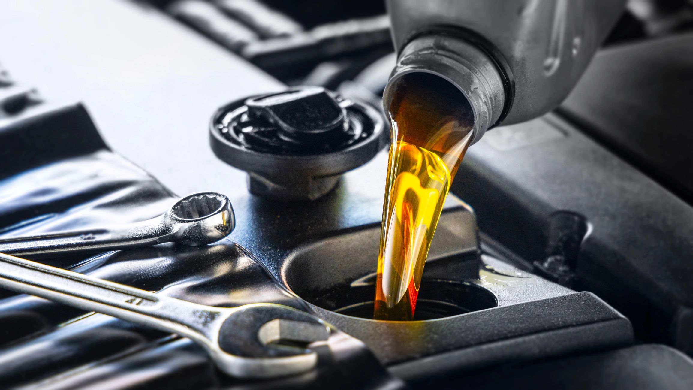 Oil change service being performed on an engine