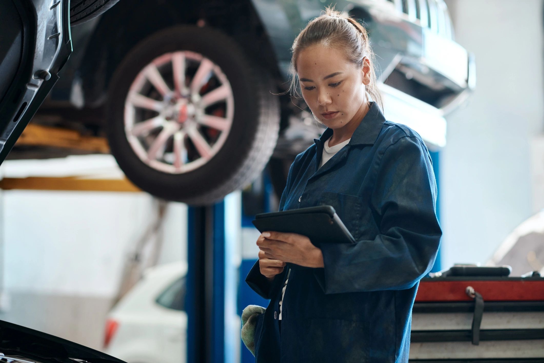 Technician holding a tablet while performing a system check