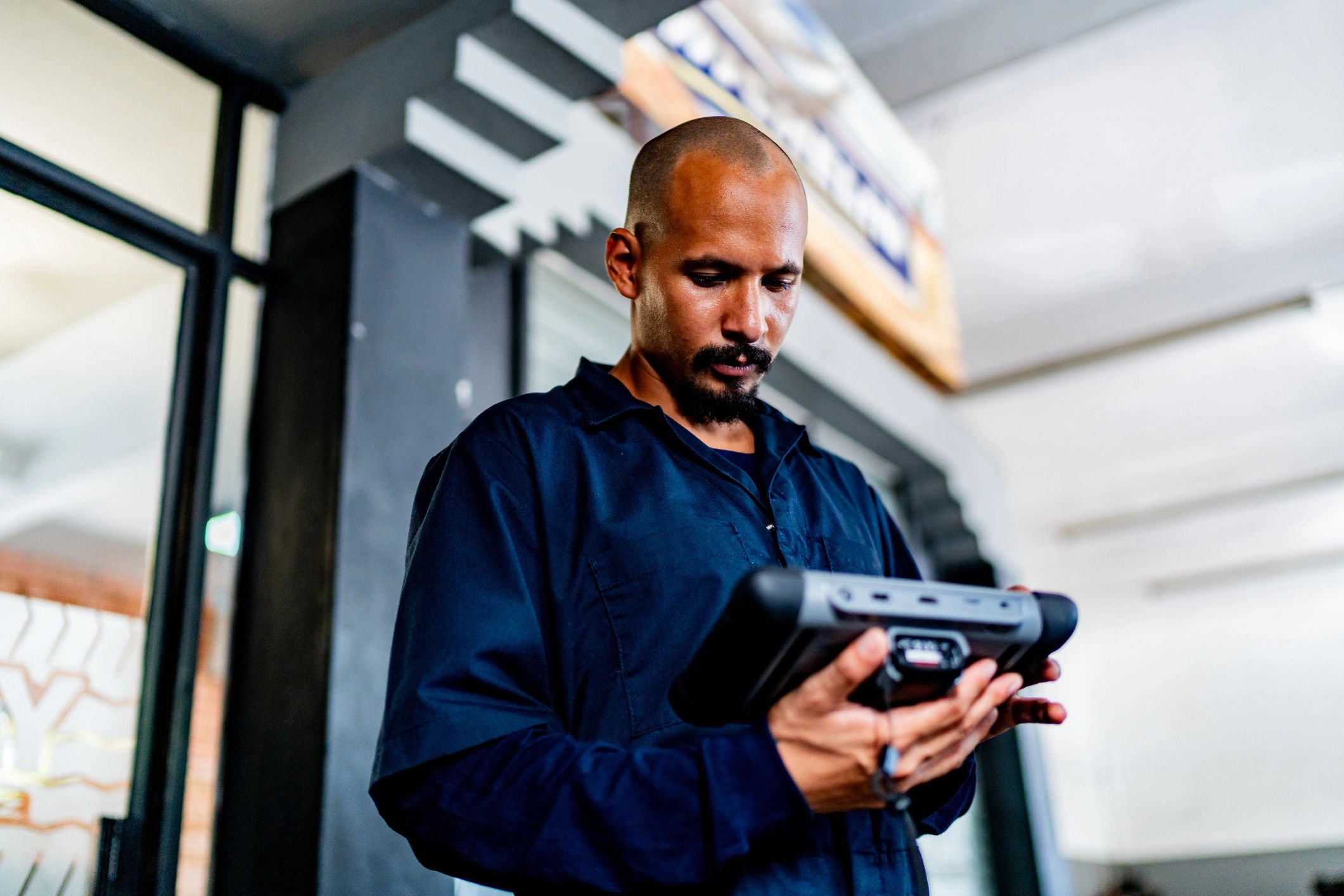 Mechanic using a diagnostic scanner in an auto repair shop
