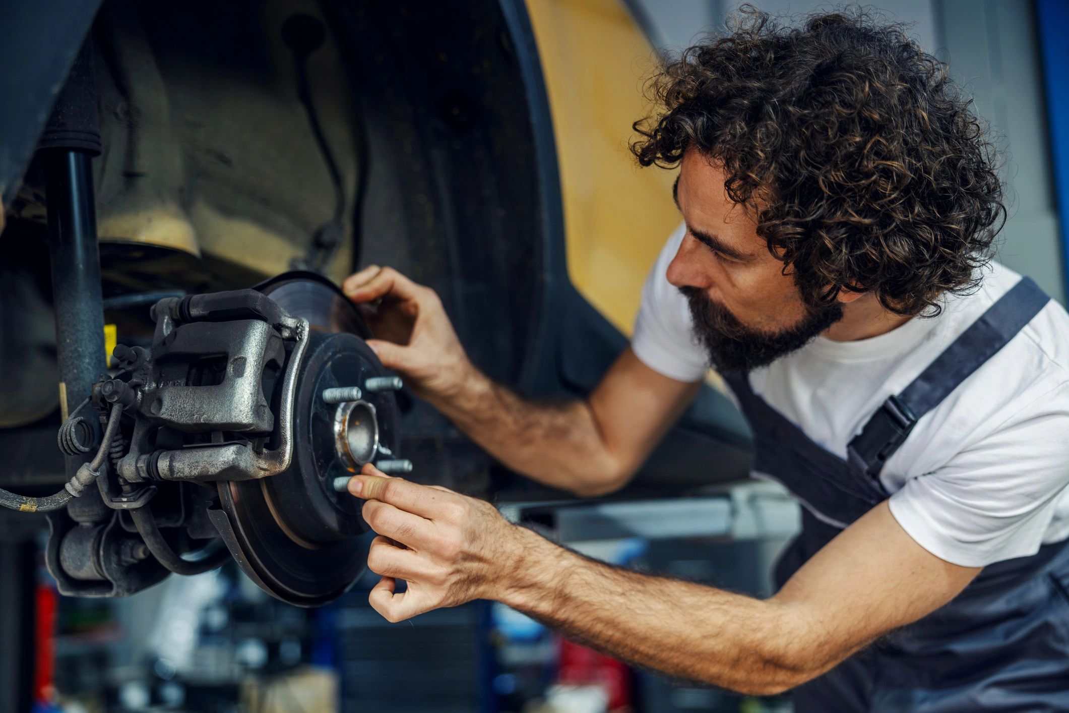 Mechanic working on a brake system in a garage